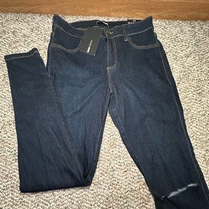 Fashion Nova Dark Knee Rip Jeans.